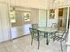 Covered porch boasts tiled floors and outdoor seating, creating a relaxing extension of the home at 700 Dolphin Pkwy, Punta Gorda, FL 33950