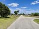 A street view of a quiet neighborhood featuring mature trees, well-kept lawns, and attractive homes at 700 Dolphin Pkwy, Punta Gorda, FL 33950