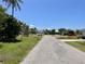 Picturesque street view in a neighborhood with lush tropical landscaping and well-maintained homes on a sunny day at 700 Dolphin Pkwy, Punta Gorda, FL 33950