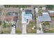 Aerial view of a home with a screened-in pool, well-maintained yard, and a modern metal roof at 7333 Watson Ln, Port Charlotte, FL 33981