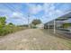 Expansive backyard with potential and a view of the pool's screened-in lanai at 7333 Watson Ln, Port Charlotte, FL 33981