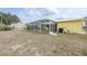 Spacious backyard with a screened-in pool area and well-maintained lawn, creating a private outdoor space at 7333 Watson Ln, Port Charlotte, FL 33981