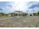 Backyard view of a screened-in pool, a patio and an outbuilding, creating a private outdoor space at 7333 Watson Ln, Port Charlotte, FL 33981