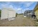 The backyard featuring a storage shed and screened-in lanai with a pool at 7333 Watson Ln, Port Charlotte, FL 33981