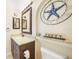 Stylish bathroom featuring granite counters, dark wood cabinetry, and coastal decor at 7333 Watson Ln, Port Charlotte, FL 33981