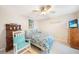 Comfortable bedroom featuring ceiling fan, TV, desk and rocking chair at 7333 Watson Ln, Port Charlotte, FL 33981