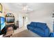 Comfortable bedroom area featuring a blue sofa, TV, and access to the other rooms at 7333 Watson Ln, Port Charlotte, FL 33981