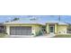 Charming single-story home with a metal roof, screened garage, and a cozy front porch at 7333 Watson Ln, Port Charlotte, FL 33981