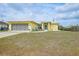 The home features a well-maintained lawn, front porch, and attached garage at 7333 Watson Ln, Port Charlotte, FL 33981