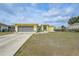 The home boasts a well-maintained lawn, front porch, and attached garage at 7333 Watson Ln, Port Charlotte, FL 33981