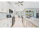 Modern kitchen featuring white cabinets, stainless steel appliances, and a marble countertop at 7333 Watson Ln, Port Charlotte, FL 33981
