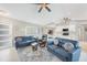 Spacious living room with comfortable seating, neutral decor, and an open layout to the kitchen at 7333 Watson Ln, Port Charlotte, FL 33981