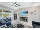 Cozy living room with vaulted ceilings, tile flooring, and a view of the screened-in lanai at 7333 Watson Ln, Port Charlotte, FL 33981