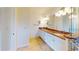Bathroom featuring a granite countertop, double sinks, walk-in shower, and tile floors at 745 Monaco Dr, Punta Gorda, FL 33950