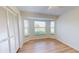 Bright bedroom with bay windows, wood-look flooring, and closet at 745 Monaco Dr, Punta Gorda, FL 33950