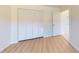 Bedroom features wood flooring, closet, and neutral paint at 745 Monaco Dr, Punta Gorda, FL 33950