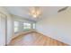 Cozy bedroom with wood-look flooring, bay window, ceiling fan, and ample natural light at 745 Monaco Dr, Punta Gorda, FL 33950
