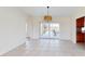 Open dining room features tile floors and sliding doors to a screened lanai with pool at 745 Monaco Dr, Punta Gorda, FL 33950