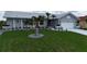 Charming one-story home featuring a well-manicured lawn, mature palm trees and a one-car garage at 745 Monaco Dr, Punta Gorda, FL 33950