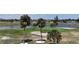 Beautiful golf course and water view from your home featuring a green, water, and palm trees at 745 Monaco Dr, Punta Gorda, FL 33950