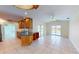 Open kitchen with granite countertops, wooden cabinets, tile floors, and access to the pool at 745 Monaco Dr, Punta Gorda, FL 33950