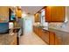 Bright kitchen with granite countertops, tile floors, stainless steel appliances, and wooden cabinets at 745 Monaco Dr, Punta Gorda, FL 33950
