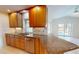 Well-lit kitchen with granite countertops, stainless steel appliances, and ample wooden cabinet space at 745 Monaco Dr, Punta Gorda, FL 33950