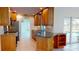 Open kitchen with wood cabinets, granite countertops, stainless steel appliances, and pool view at 745 Monaco Dr, Punta Gorda, FL 33950