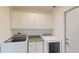 Laundry room with washer, dryer, and cabinets at 745 Monaco Dr, Punta Gorda, FL 33950