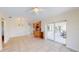 Spacious living room with tile flooring, ceiling fan, and sliding doors to screened patio at 745 Monaco Dr, Punta Gorda, FL 33950