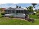 Enjoy a private screened-in pool area, surrounded by lush landscaping and privacy at 745 Monaco Dr, Punta Gorda, FL 33950