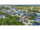 Aerial view of the homes on a canal with mature trees and lush landscaping at 9239 Impala Cir, Port Charlotte, FL 33981