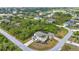 Aerial view of the home on a corner lot, lush landscaping, and private pool at 9239 Impala Cir, Port Charlotte, FL 33981