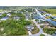 Aerial view of the home with canal access surrounded by mature trees and lush landscaping at 9239 Impala Cir, Port Charlotte, FL 33981