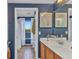 Bathroom with vanity sink, a door leading to shower and a view of the outdoor through the window at 9239 Impala Cir, Port Charlotte, FL 33981