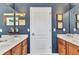 Bathroom with vanity sink and white door and dark blue walls with vanity mirrors at 9239 Impala Cir, Port Charlotte, FL 33981