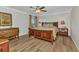 Comfortable bedroom with a wooden sleigh bed, hardwood floors, and a ceiling fan at 9239 Impala Cir, Port Charlotte, FL 33981