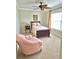 Cozy bedroom features a ceiling fan, neutral carpeting, and a comfortable sitting chair at 9239 Impala Cir, Port Charlotte, FL 33981