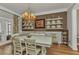 Bright dining room with a chandelier, hardwood floors, and a view into the living room at 9239 Impala Cir, Port Charlotte, FL 33981