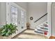 Welcoming foyer with decorative glass doors, tile flooring, and staircase access at 9239 Impala Cir, Port Charlotte, FL 33981