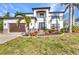Stunning two-story home with a well-manicured lawn, fountain, and lush landscaping at 9239 Impala Cir, Port Charlotte, FL 33981