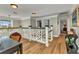 Upstairs hallway with detailed banister, hardwood floors, and modern lighting at 9239 Impala Cir, Port Charlotte, FL 33981