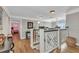 Upstairs hallway with detailed banister, hardwood floors, and multiple doorways at 9239 Impala Cir, Port Charlotte, FL 33981