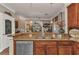 Kitchen featuring granite countertops, wooden cabinets, and modern stainless steel dishwasher at 9239 Impala Cir, Port Charlotte, FL 33981