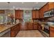 Traditional kitchen featuring granite countertops, stainless steel appliances, and wood cabinetry at 9239 Impala Cir, Port Charlotte, FL 33981
