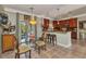 Eat-in kitchen features breakfast bar seating, decorative lighting, and access to outdoor balcony at 9239 Impala Cir, Port Charlotte, FL 33981