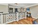 Upstairs landing with decorative railings, hardwood floors, and elegant decor at 9239 Impala Cir, Port Charlotte, FL 33981