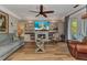 Spacious living room featuring built-in shelving, a fireplace, and glass coffee table at 9239 Impala Cir, Port Charlotte, FL 33981