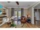 Cozy living room with hardwood floors, a ceiling fan, and French doors to the patio at 9239 Impala Cir, Port Charlotte, FL 33981