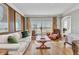 Bright living room featuring hardwood floors, large window, and comfortable seating at 9239 Impala Cir, Port Charlotte, FL 33981